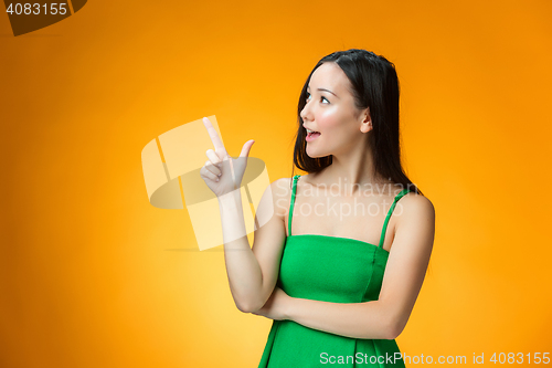 Image of The happy Chinese girl on yellow background