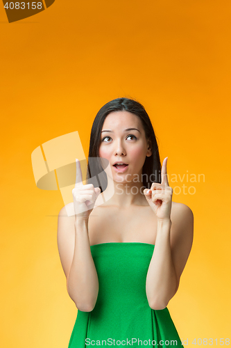 Image of The happy Chinese girl on yellow background