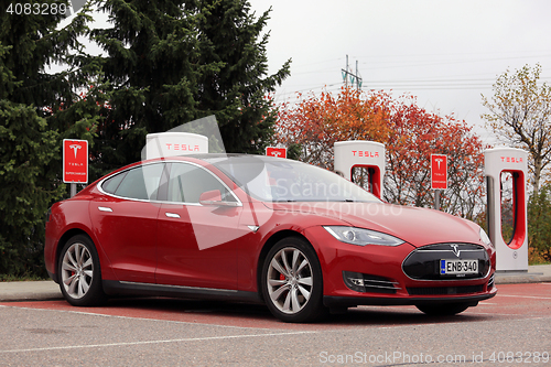 Image of Red Tesla Model S Electric Car Charging