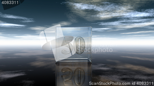 Image of number fifty in glass cube under cloudy sky - 3d rendering