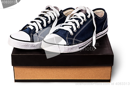 Image of Dark blue sports shoes on the cardboard box