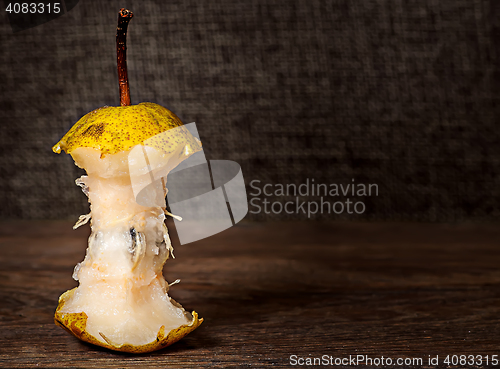 Image of Stub of pear on wooden table