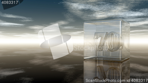 Image of number seventy in glass cube under cloudy sky - 3d rendering