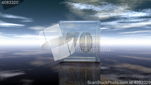 Image of number seventy in glass cube under cloudy sky - 3d rendering