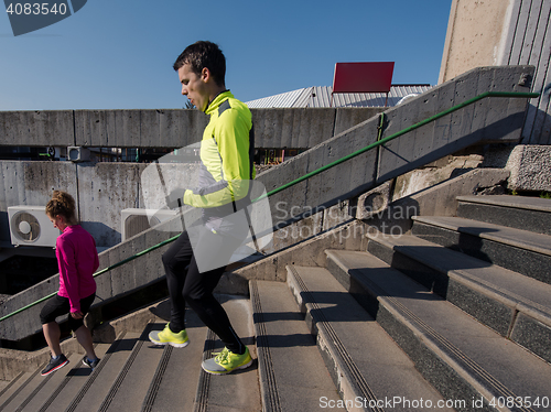 Image of young  couple jogging on steps