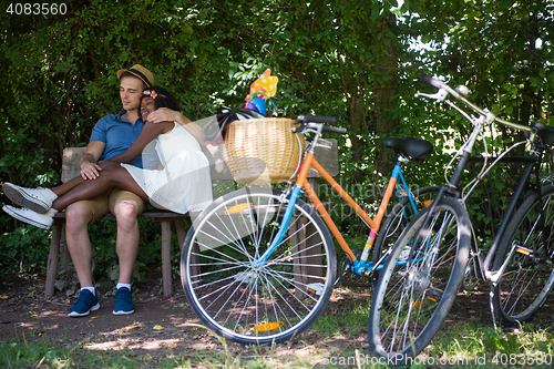 Image of Young multiethnic couple having a bike ride in nature