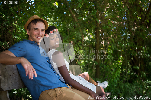 Image of Young multiethnic couple having a bike ride in nature