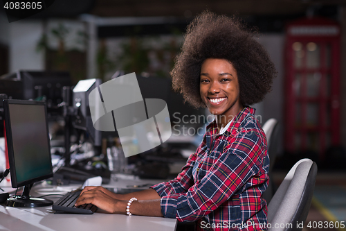 Image of portrait of a young African American woman in modern office