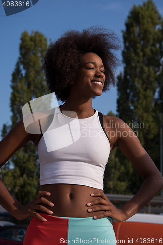 Image of Portrait of sporty young african american woman running outdoors