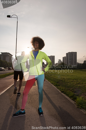 Image of Portrait of sporty young african american woman running outdoors