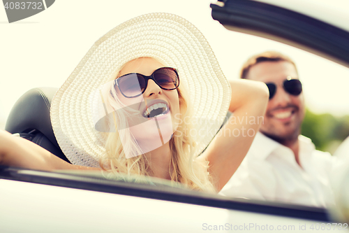 Image of happy man and woman driving in cabriolet car