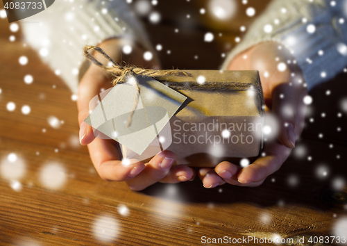 Image of close up of woman with christmas gift or parcel