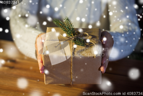 Image of close up of woman with christmas gift or parcel