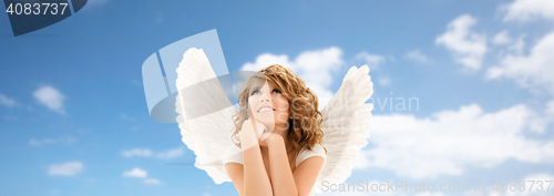 Image of happy young woman or teen girl with angel wings