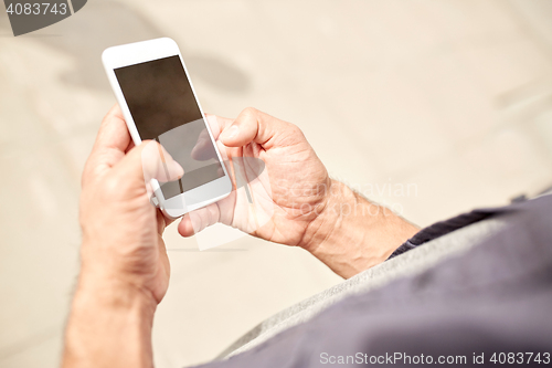 Image of close up of man with smartphone on street
