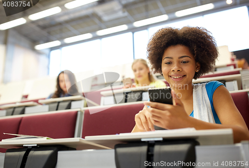 Image of african student girl with smartphone at lecture