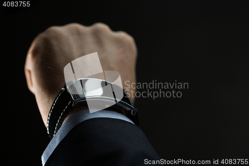 Image of close up of businessman hand with smart watch