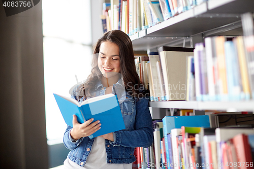 Image of high school student girl reading book at library