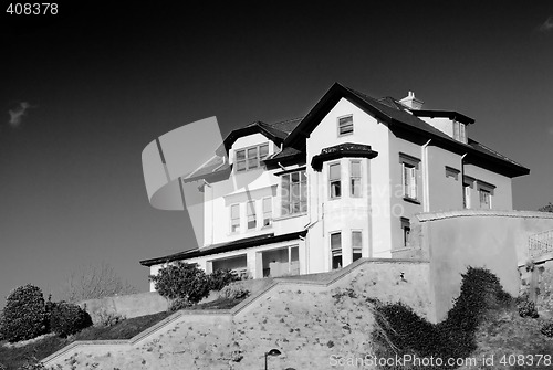 Image of Construction House architecture building with a garden in a residential area.