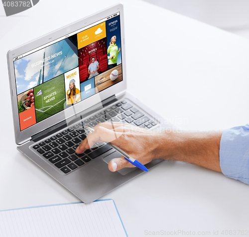 Image of businessman with laptop computer working at office