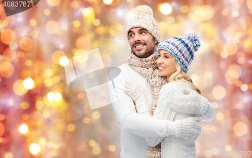 Image of smiling couple in winter clothes hugging