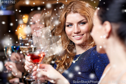 Image of happy women with drinks at night club