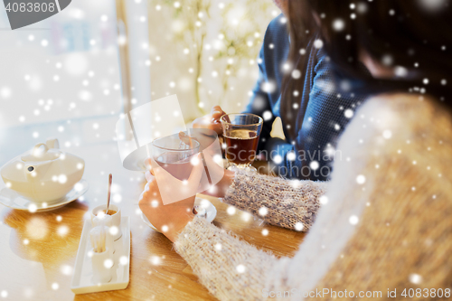 Image of close up of couple drinking tea at cafe