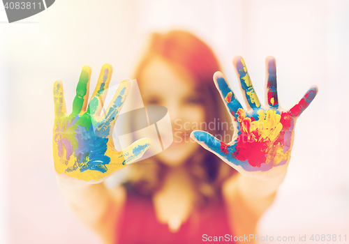 Image of happy girl showing painted hands