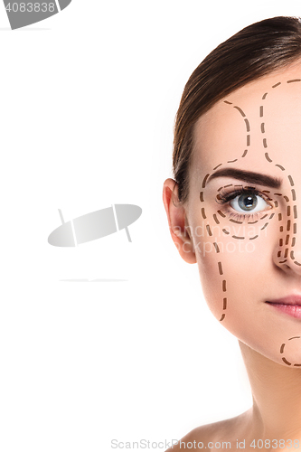 Image of The beautiful woman face with arrows close up over white background