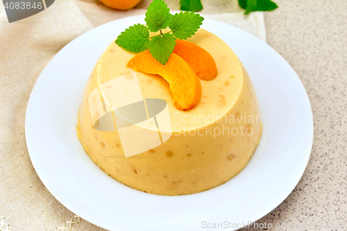 Image of Panna cotta apricot on napkin and table