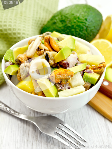 Image of Salad with seafood and avocado in bowl on white board