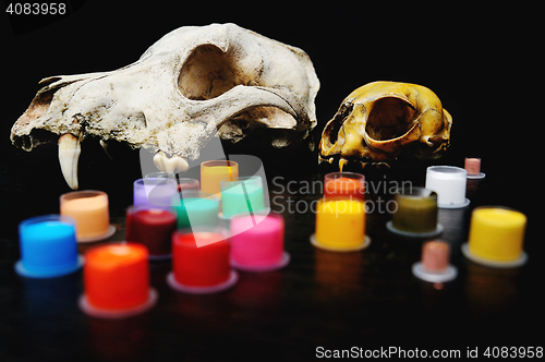 Image of Caps for tattoo ink with colored  on the background of a skull.