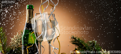 Image of Holiday champagne on background of fir-tree branches with toys