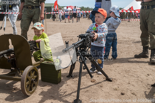 Image of The boy considers an easel machine gun