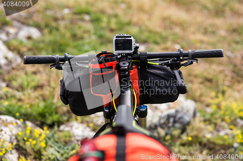 Image of Bicycle with orange bags for travel