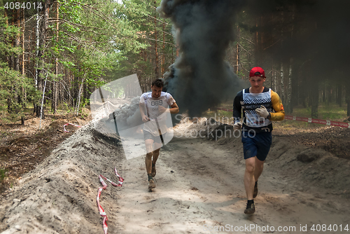 Image of Sportsmen run between stages in extrim race.Tyumen