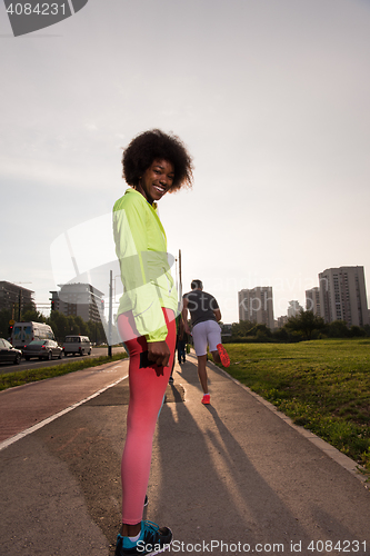 Image of Portrait of sporty young african american woman running outdoors