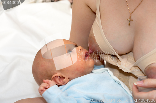 Image of Feeding infant boy