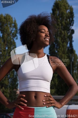 Image of Portrait of sporty young african american woman running outdoors