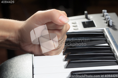 Image of Girl\'s hands on the keyboard of the piano