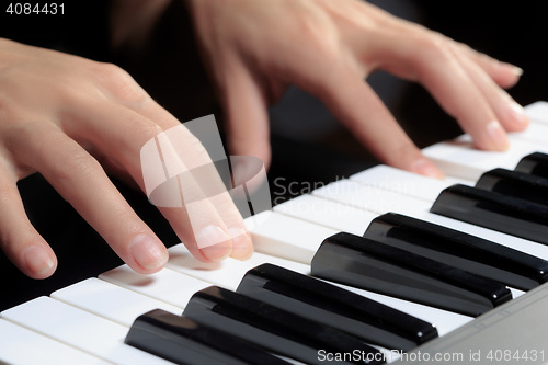 Image of Girl\'s hands on the keyboard of the piano