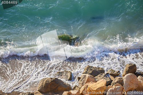 Image of Large coastal rocks and soft waves. Nature on sunny day