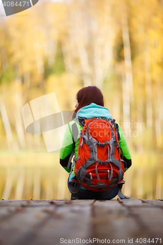 Image of Long-haired brunette with backpack