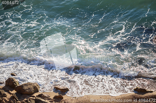 Image of Beautiful sea landscape with crystal clear waves and coastal boulders