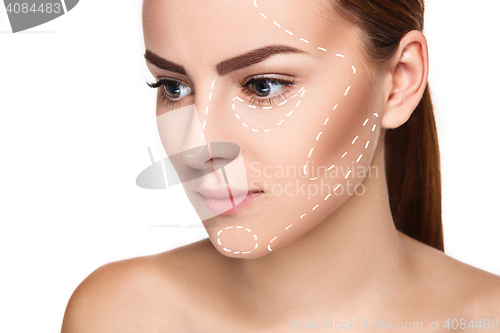 Image of The beautiful woman face with arrows close up over white background