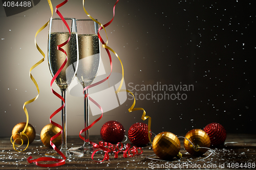 Image of Two glasses with champagne and Christmas decoration. Holiday concept