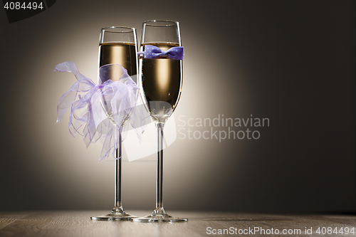 Image of Two glasses of champagne decorated bride and groom clothing
