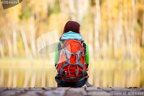 Image of Long-haired brunette with backpack