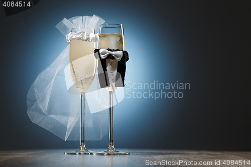 Image of Two cooled glasses of champagne decorated for married couple