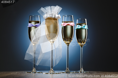 Image of Glasses of champagne for bride and gentlemens